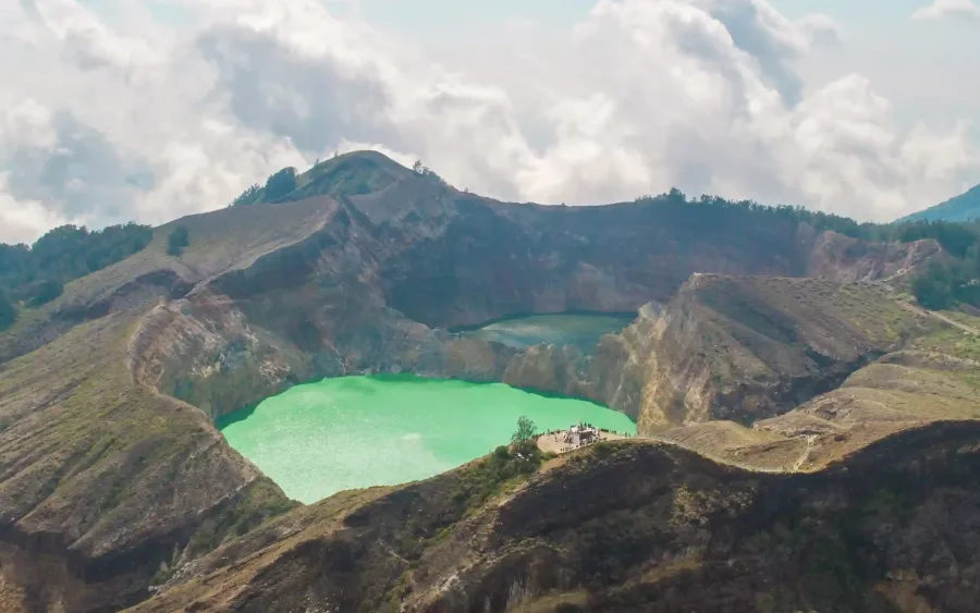 Aerial view of two Kelimutu crater lakes with the summit viewing platform on the ridge between them