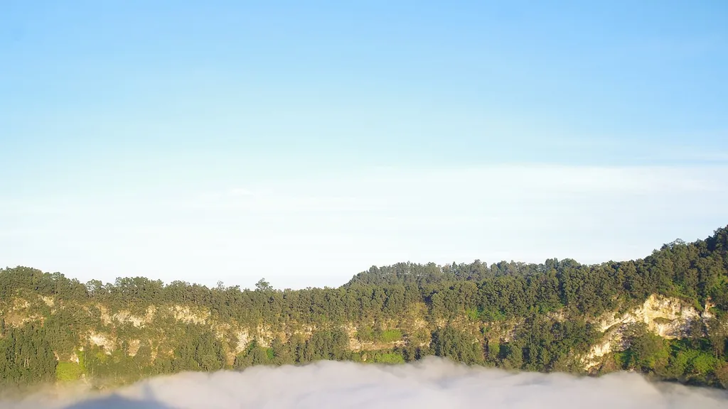 One of the Kelimutu crater lakes covered by mist, Kelimutu National Park